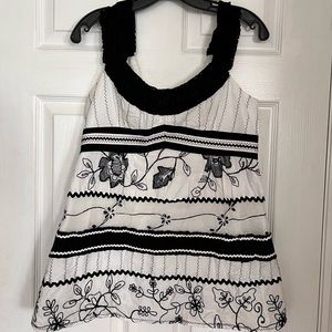 Size 10 Nanette Lepore black and white top with embroidered details.